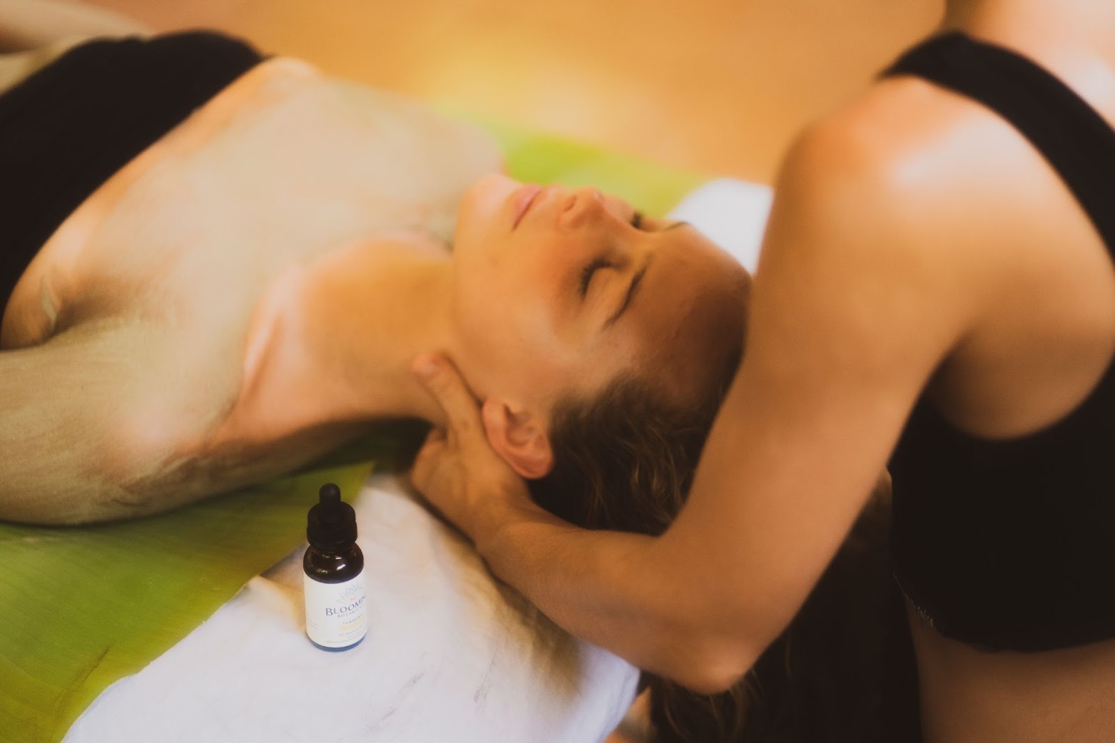 woman getting a Turmeric CBD massage with mud mask on shoulders and chest