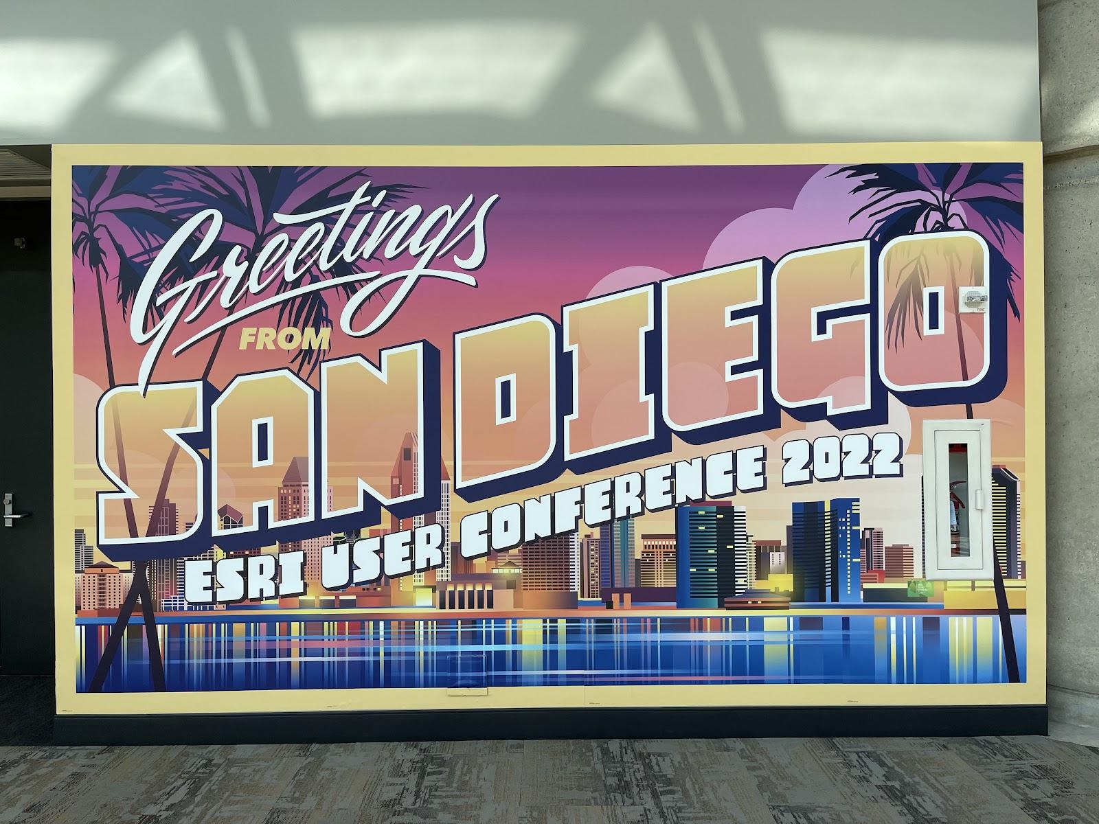A sign in the style of a large postcard that reads 'Greetings from San Diego - Esri User Conference 2022'