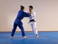 Une image contenant homme, bleu, sport, judoDescription générée automatiquement