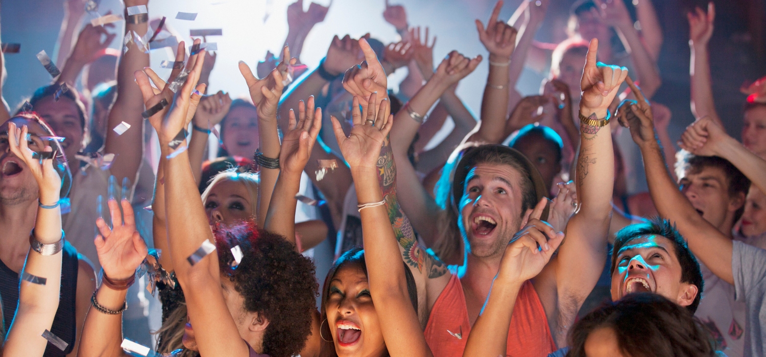 People are euphoric when they attend a DJ concert at night and they all use NFC wristbands for events from GOTAP.