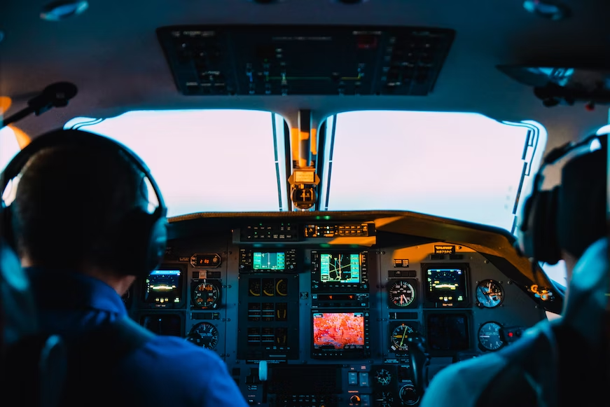 Two pilots in the cockpit of a plane