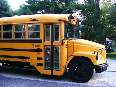 Students arrive on the first day of fourth grade on a bus