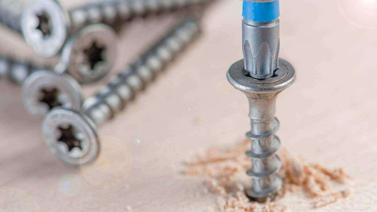 A screwdriver and screws in a wood

Description automatically generated
