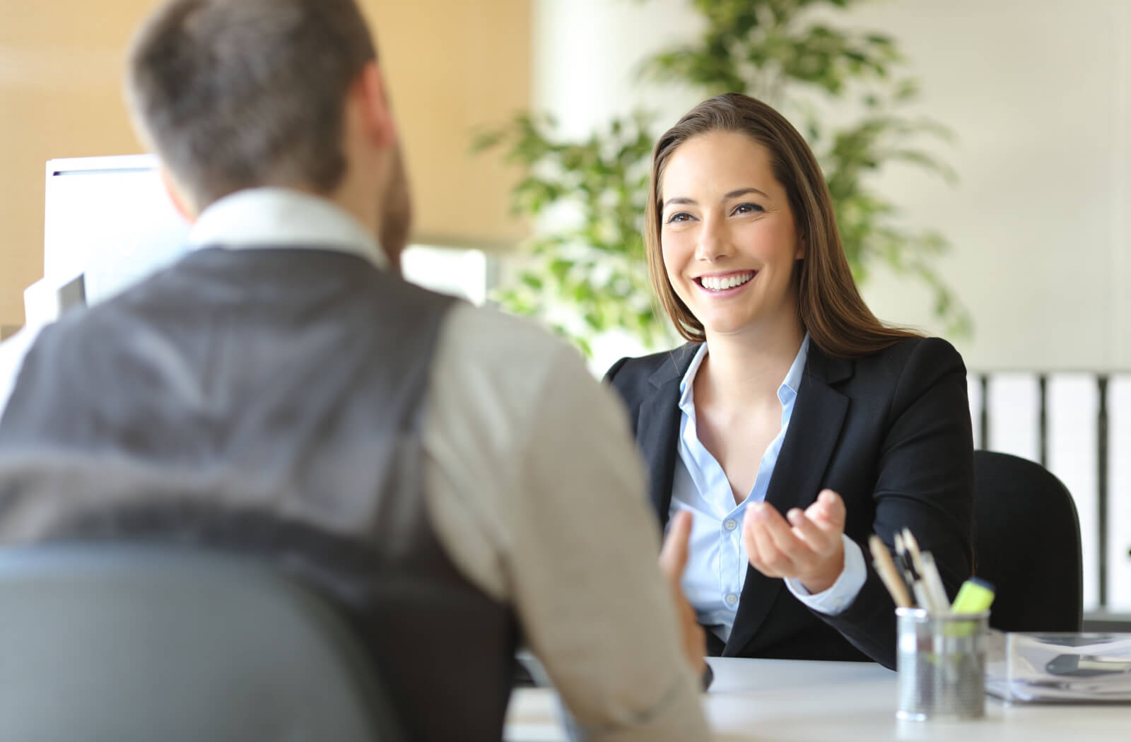 A man talking and asking financial advice from a female loan officer.