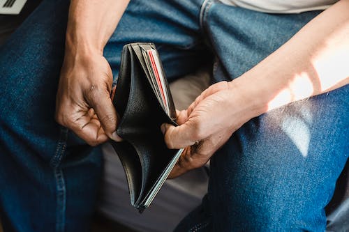 Free Man Looking at an Empty Wallet  Stock Photo