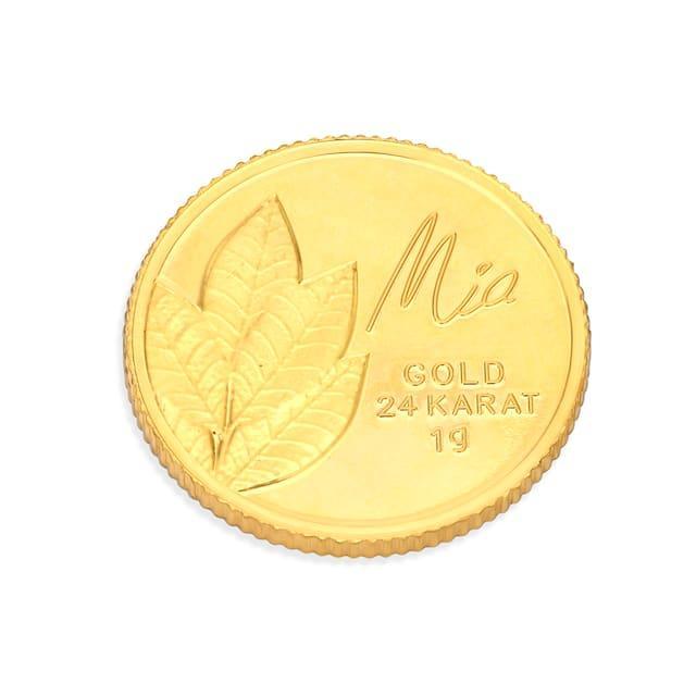 A gold coin with leaves on it

Description automatically generated