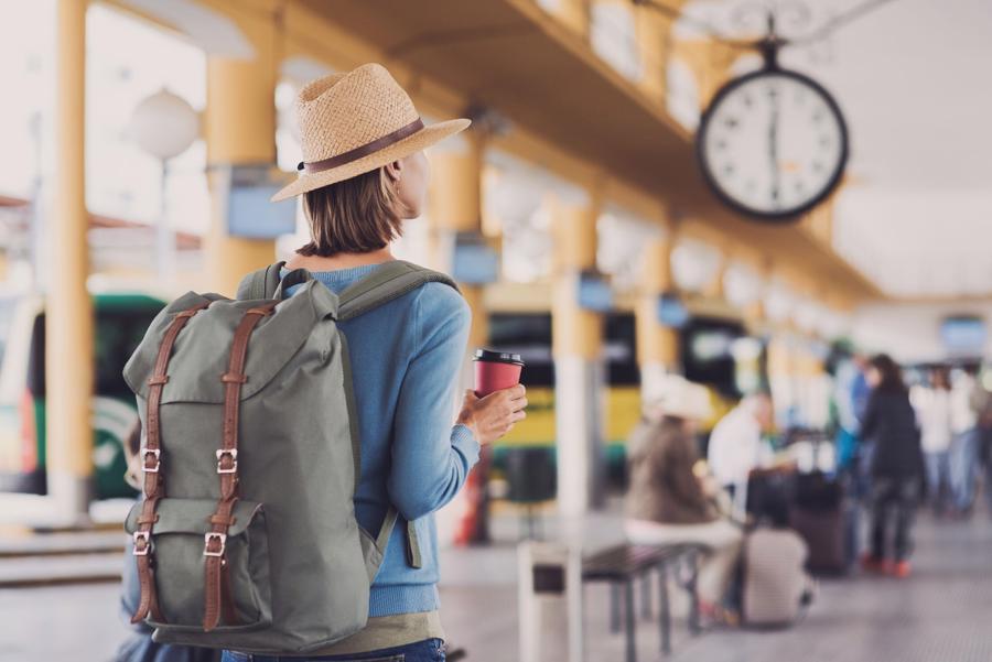 A person with a backpack and hat standing in a train station

Description automatically generated with low confidence