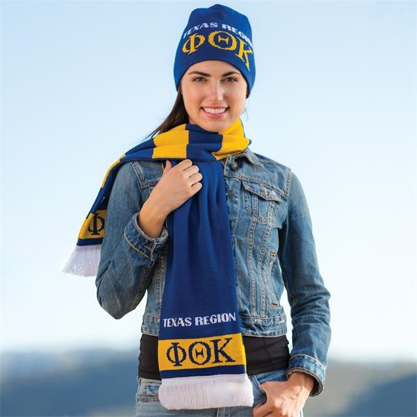a woman wearing a matching branded beanie and scarf