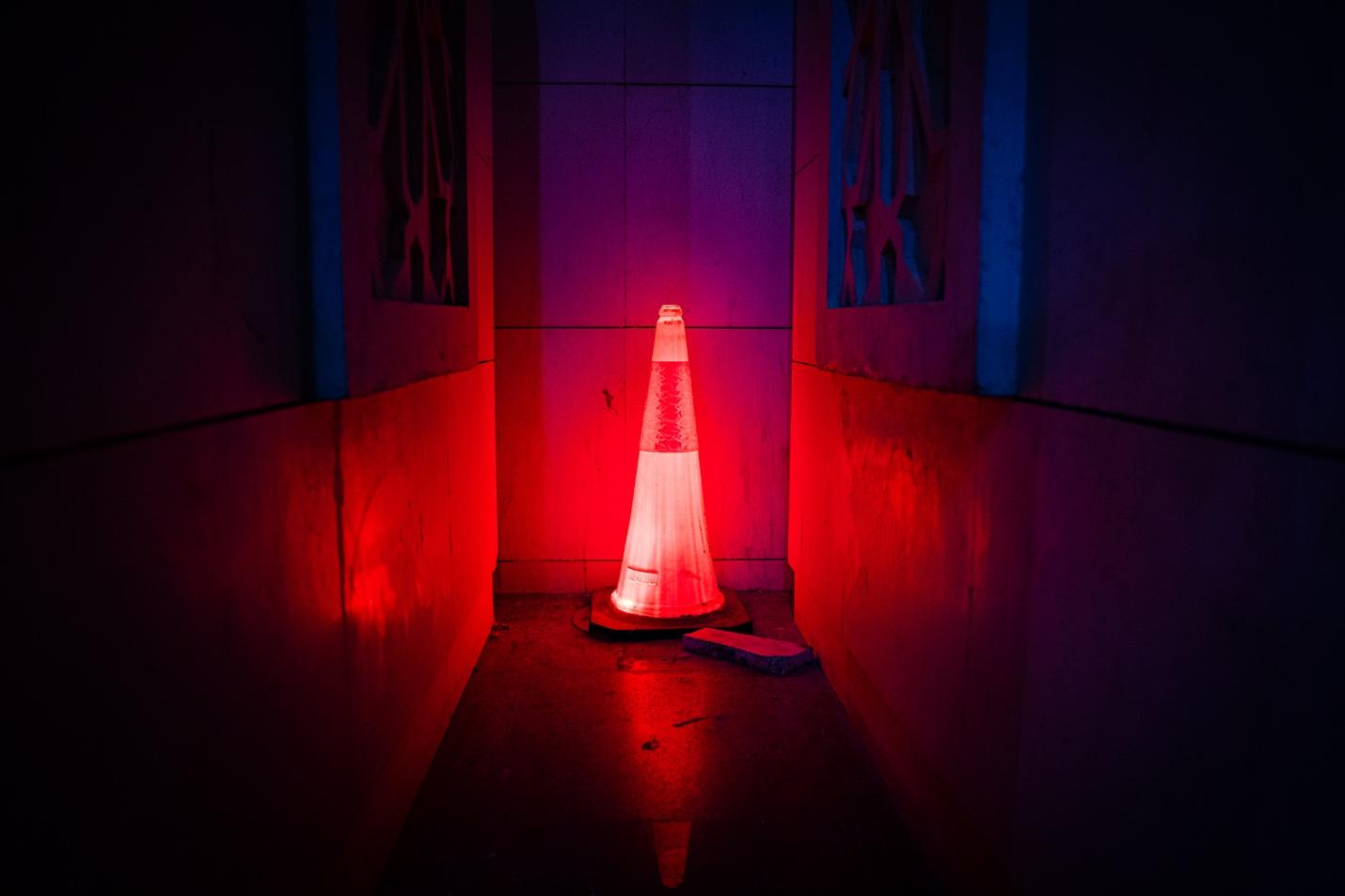White Oak Security’s Microsoft Office Zero Day: Mitigate NOW blog post image of a lot up traffic cone in a dark hallway meaning ALERT. Photo caption: Free Red Led Traffic Cone Stock Photo
