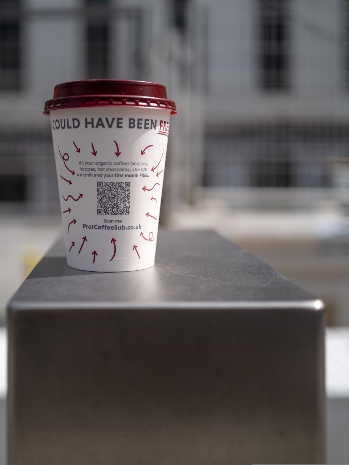 Coffee cup with barcode on a metal table