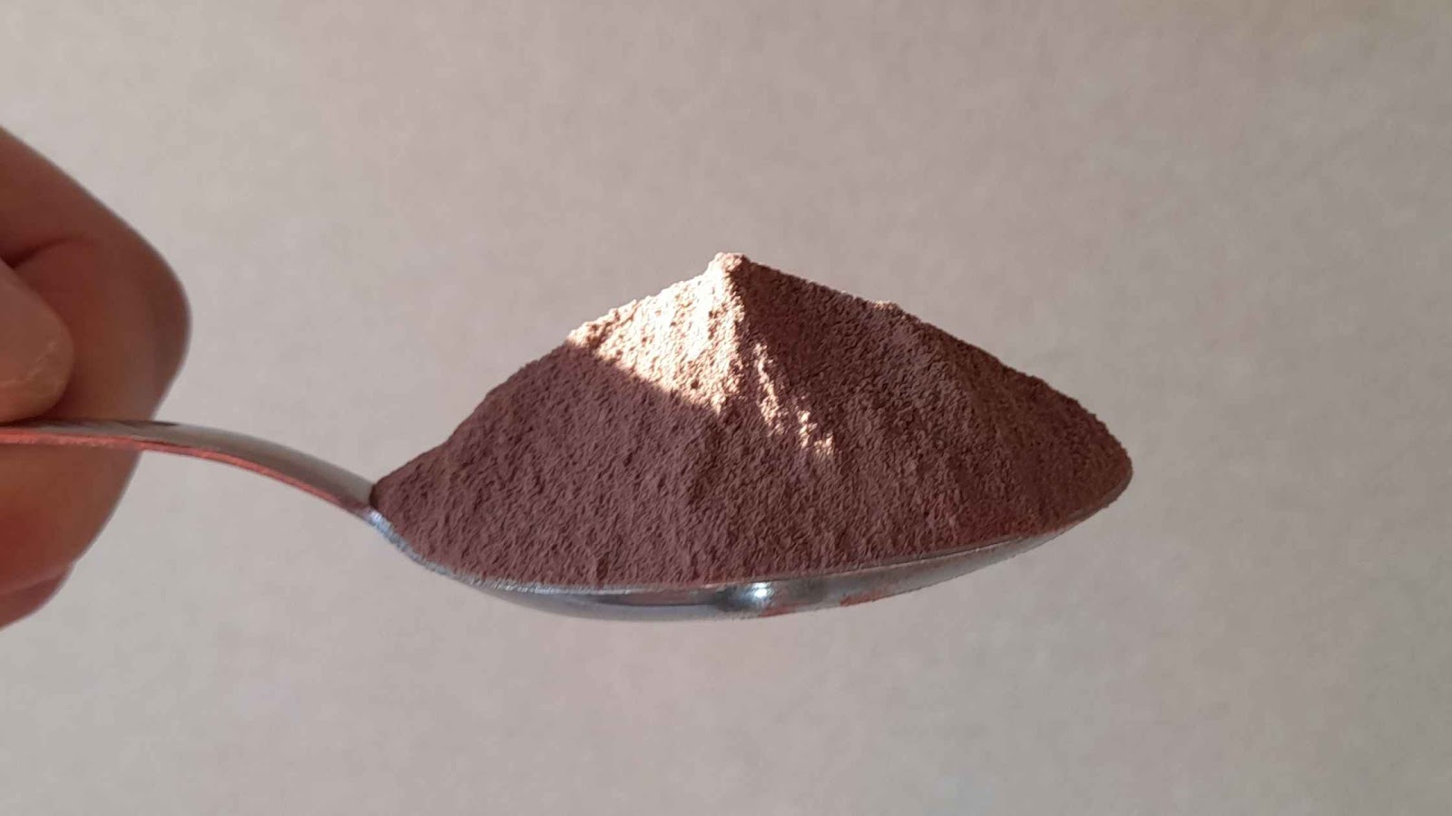An overly full tablespoon of chocolate powder.