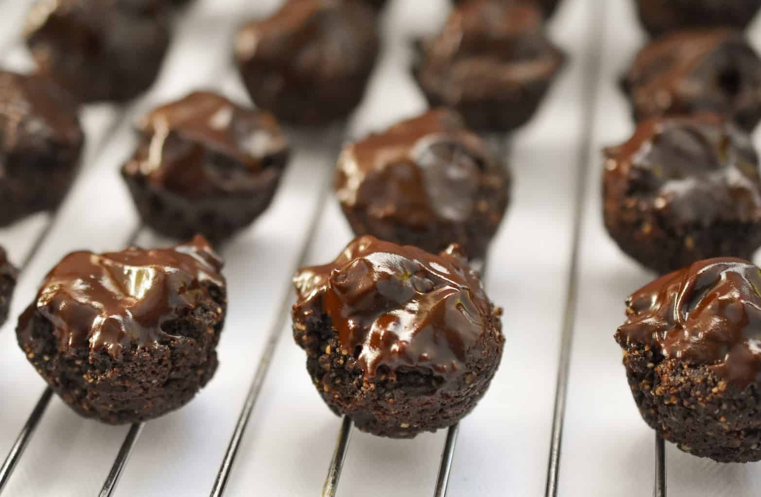 keto brownie bites on a baking rack with sugar free chocolate ganache