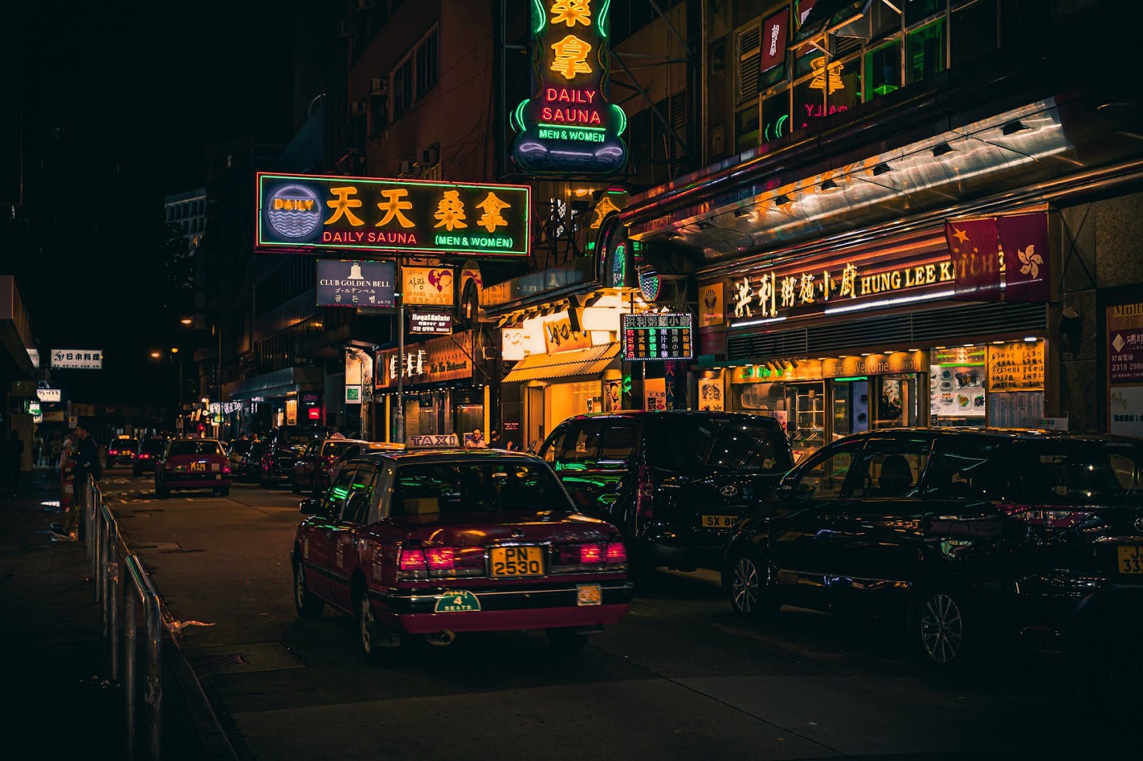 cars beside neon signages