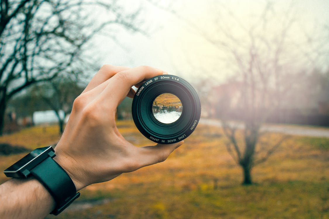 Free Photography of Person Holding Black Camera Lens Stock Photo