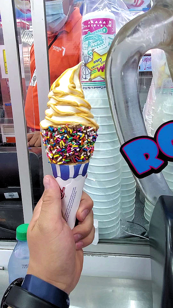 butterscotch ice cream in a rainbow sprinkled water cone