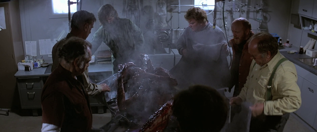 http://vignette3.wikia.nocookie.net/thething/images/8/86/The_men_examine_Split-Face_-_The_Thing_(1982).png/revision/latest?cb=20150721134612