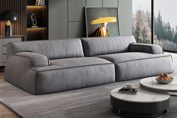 Grey fabric 3-seater sofa with cushiony armrests and seat, supported by carbon iron feet.