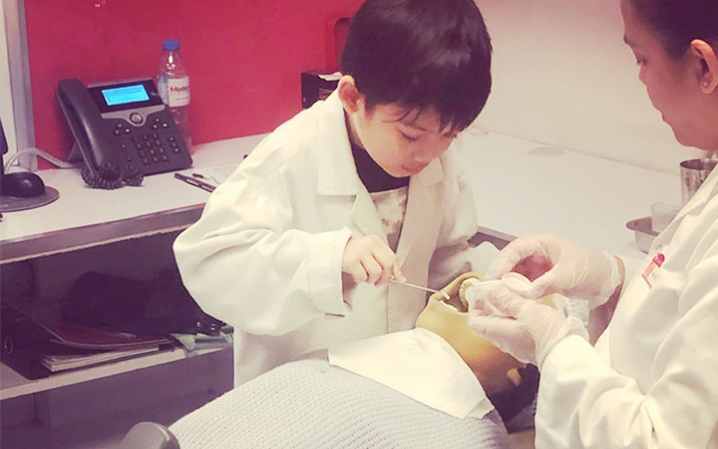 Kid trying to help a patient at KidZania Dubai