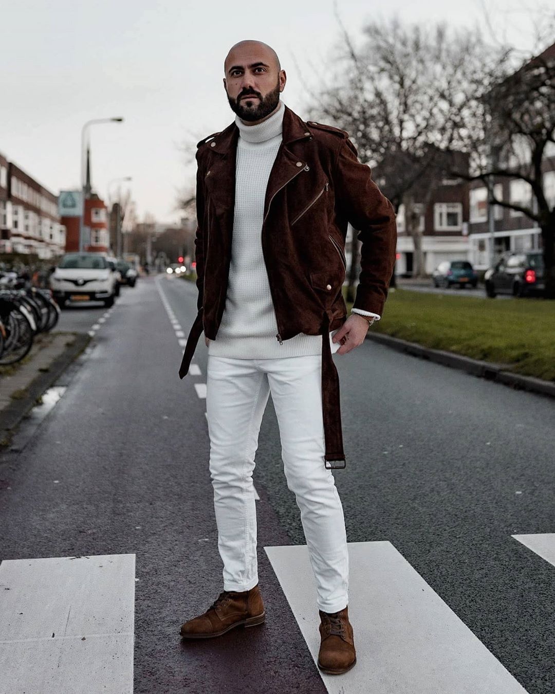 Stylish man wearing brown suede jacket over all-white outfit