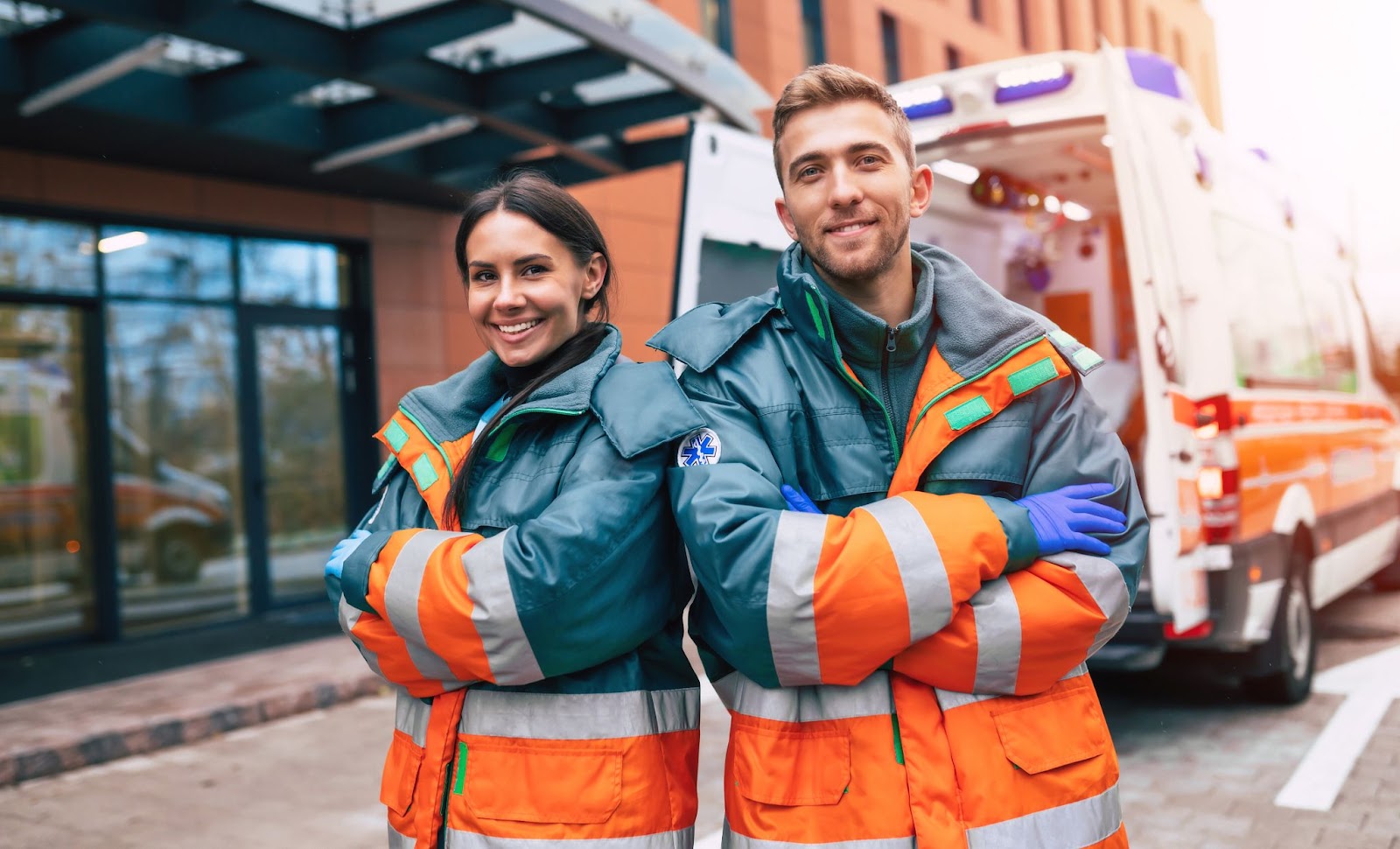 two emts standing in front of a building