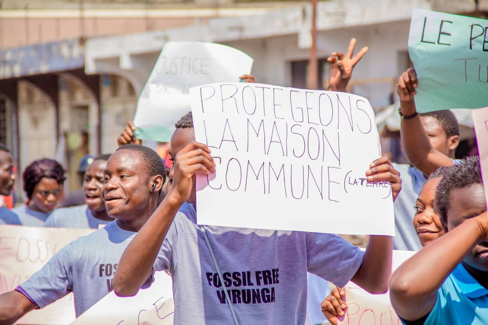 rebels in 'free virunga' t-shirts march and hold signs