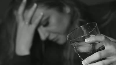 stock-footage-young-woman-drinking-alcohol-glass-in-sharp-focus-shallow-dof-black-and-white.jpg