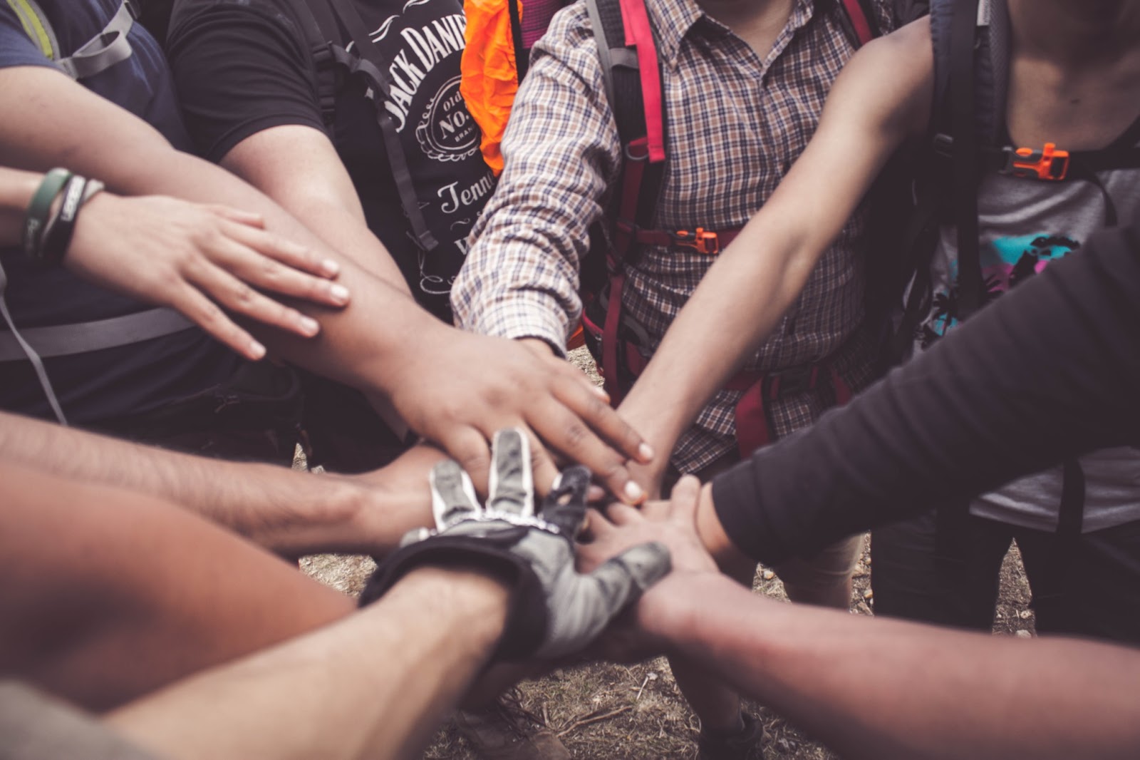 A group of people putting their hands together.