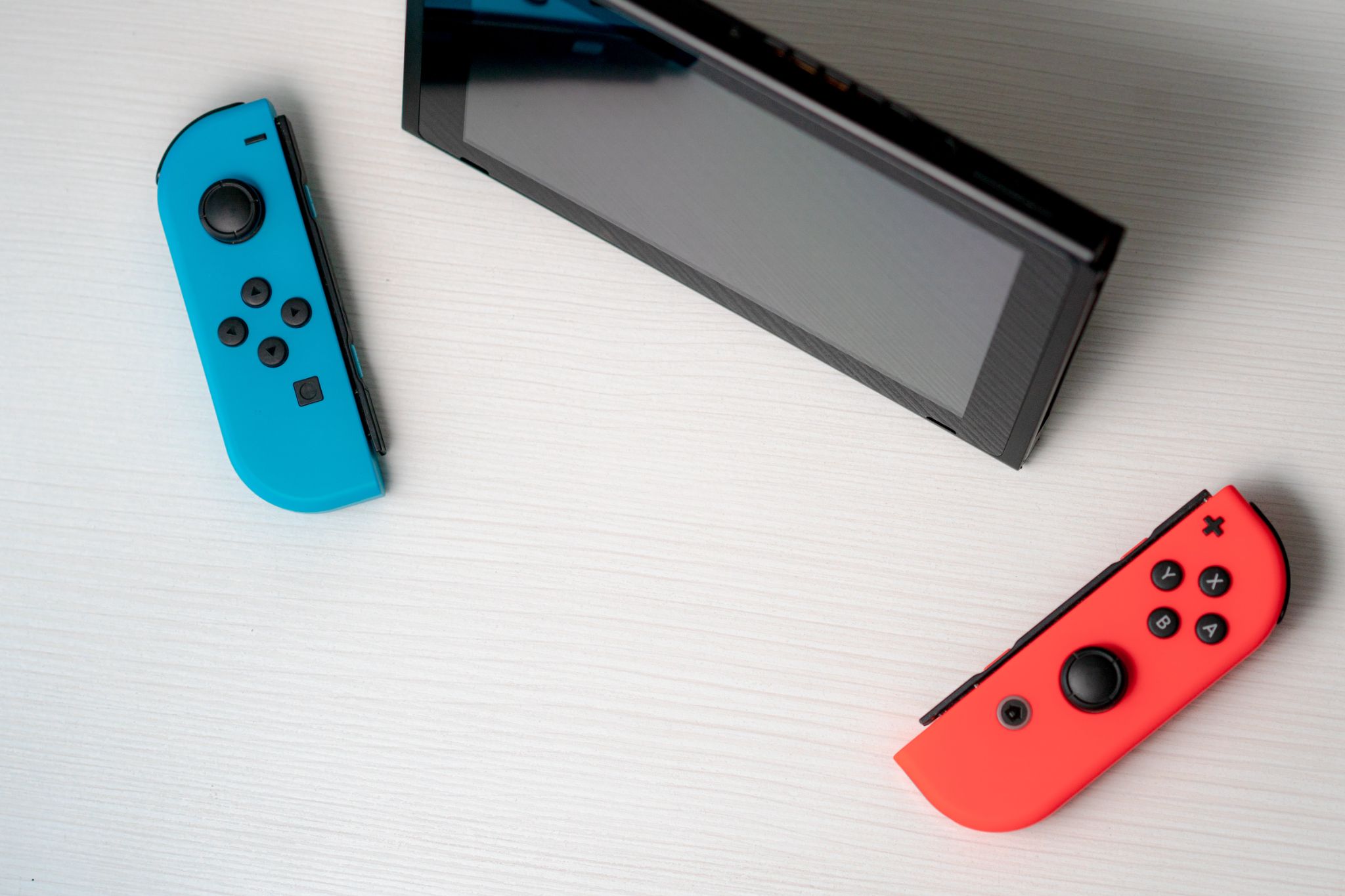A Nintendo Switch screen and game controls against a white background.