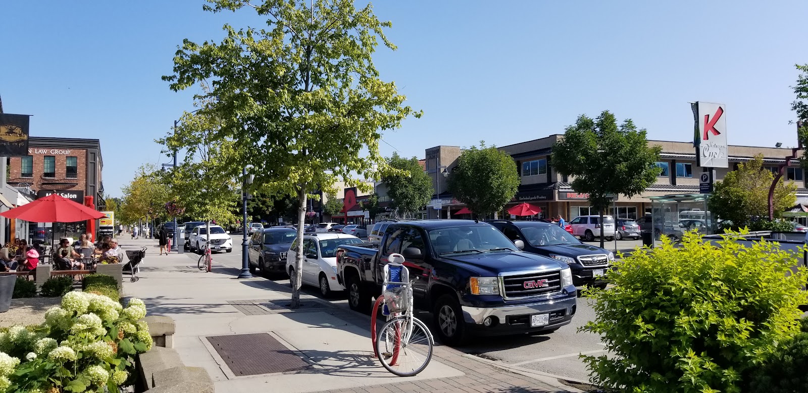 Cars and bicycles parked on the street on Pandosy Ave.