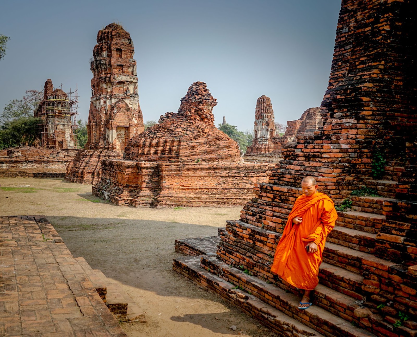 Monk walking on stairs in Ayutthaya, Thailand