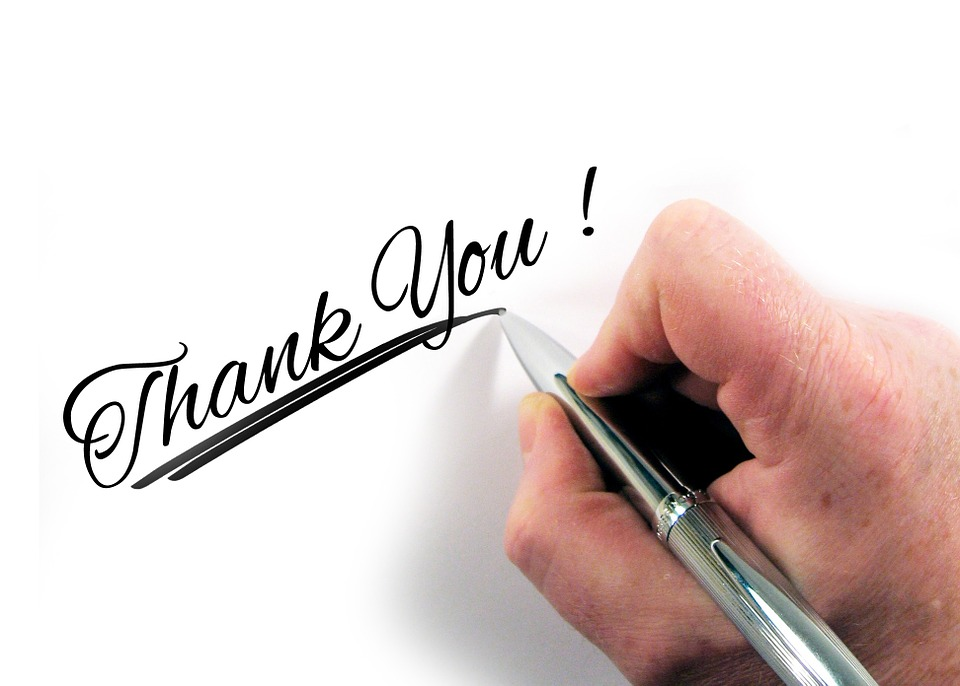 A hand writing "Thank you"