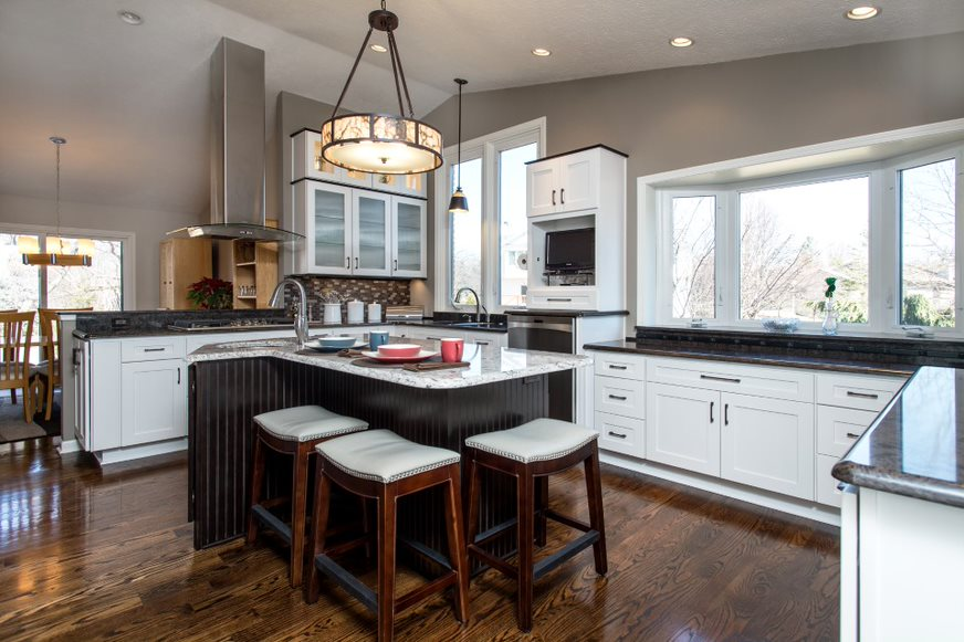 Remodeled kitchen with hardwood floors and white cabinets