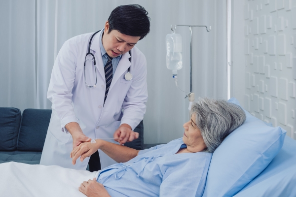 happy-smile-beautiful-asian-elderly-old-woman-patient-light-blue-dress-lying-bed-while-male-doctor-white-suit-holding-her-hand-giving-intravenous-fluid-hand-hospital-room