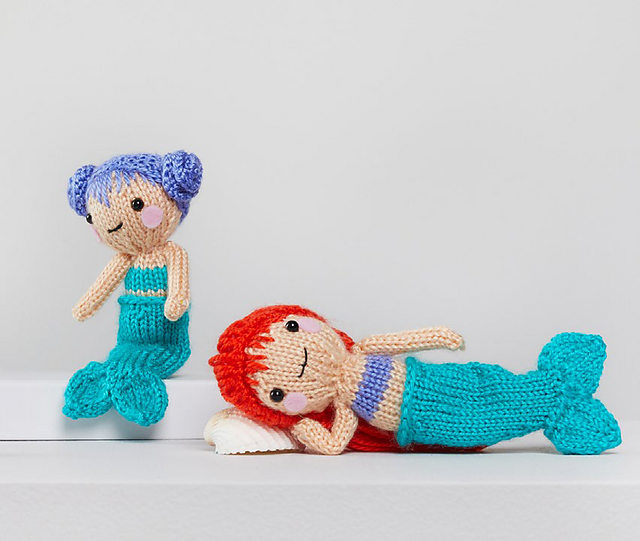 small mermaid dolls on white background