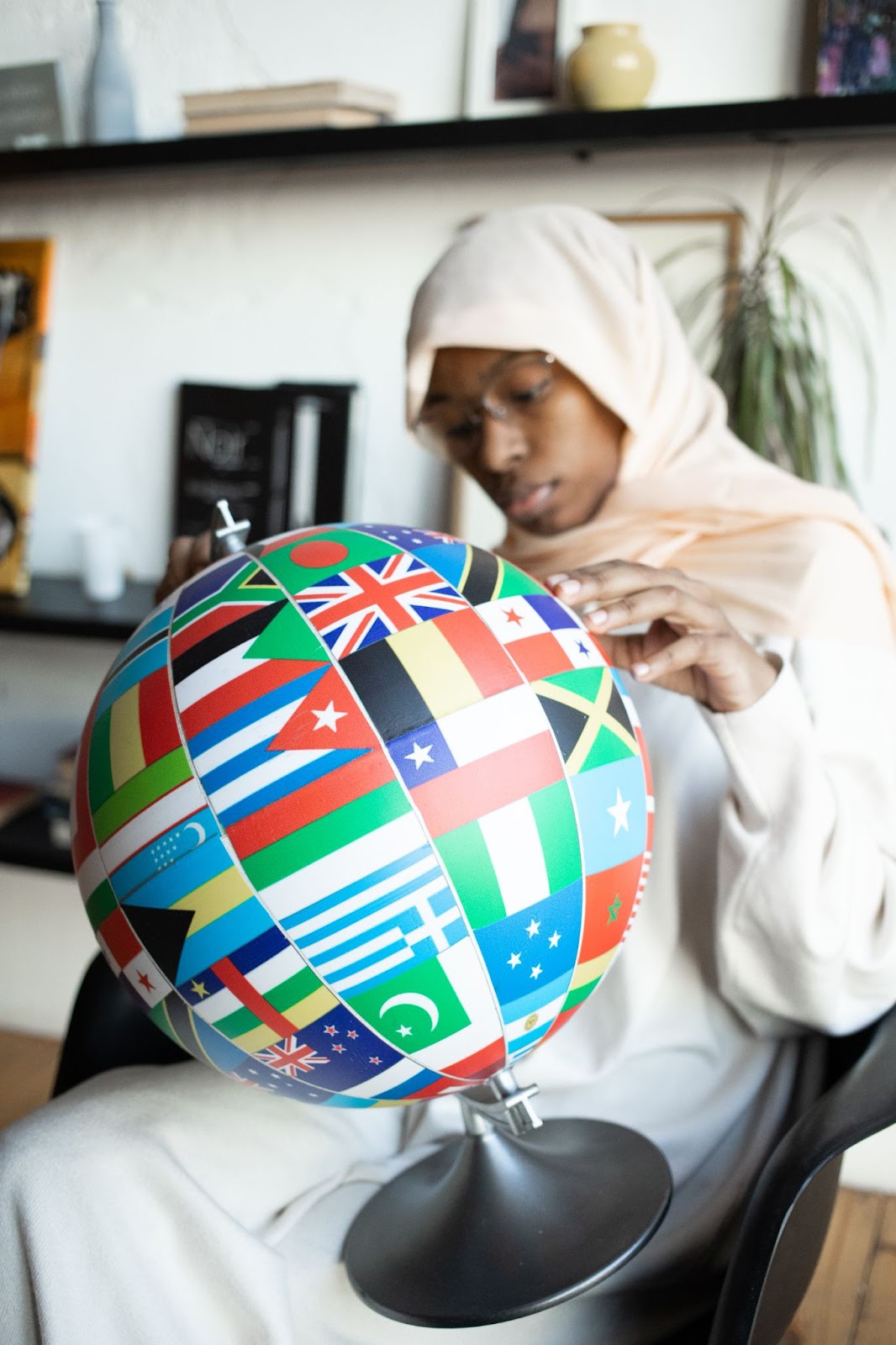 Picture of a woman holding a globe.
