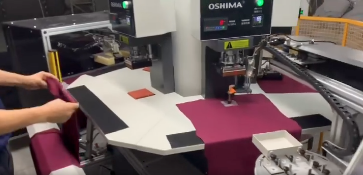 This large-scale heat transfer printing system uses heat to add a layer of ink on top of t-shirts. 
