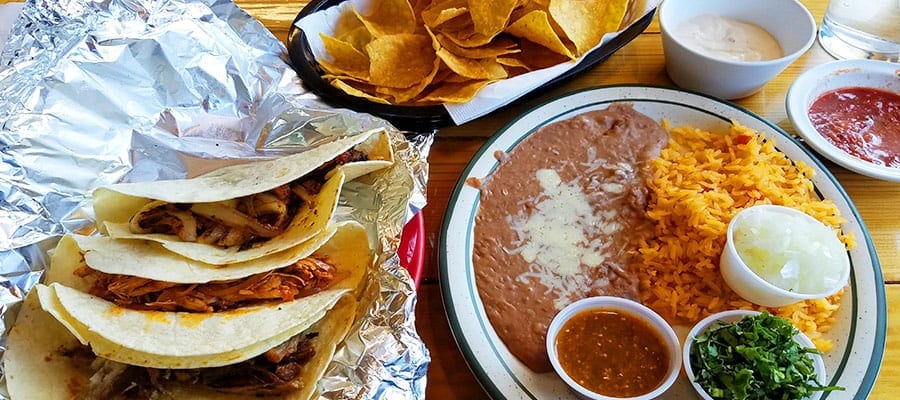 Mexican food with tacos, chips, quesadillas and refried beans