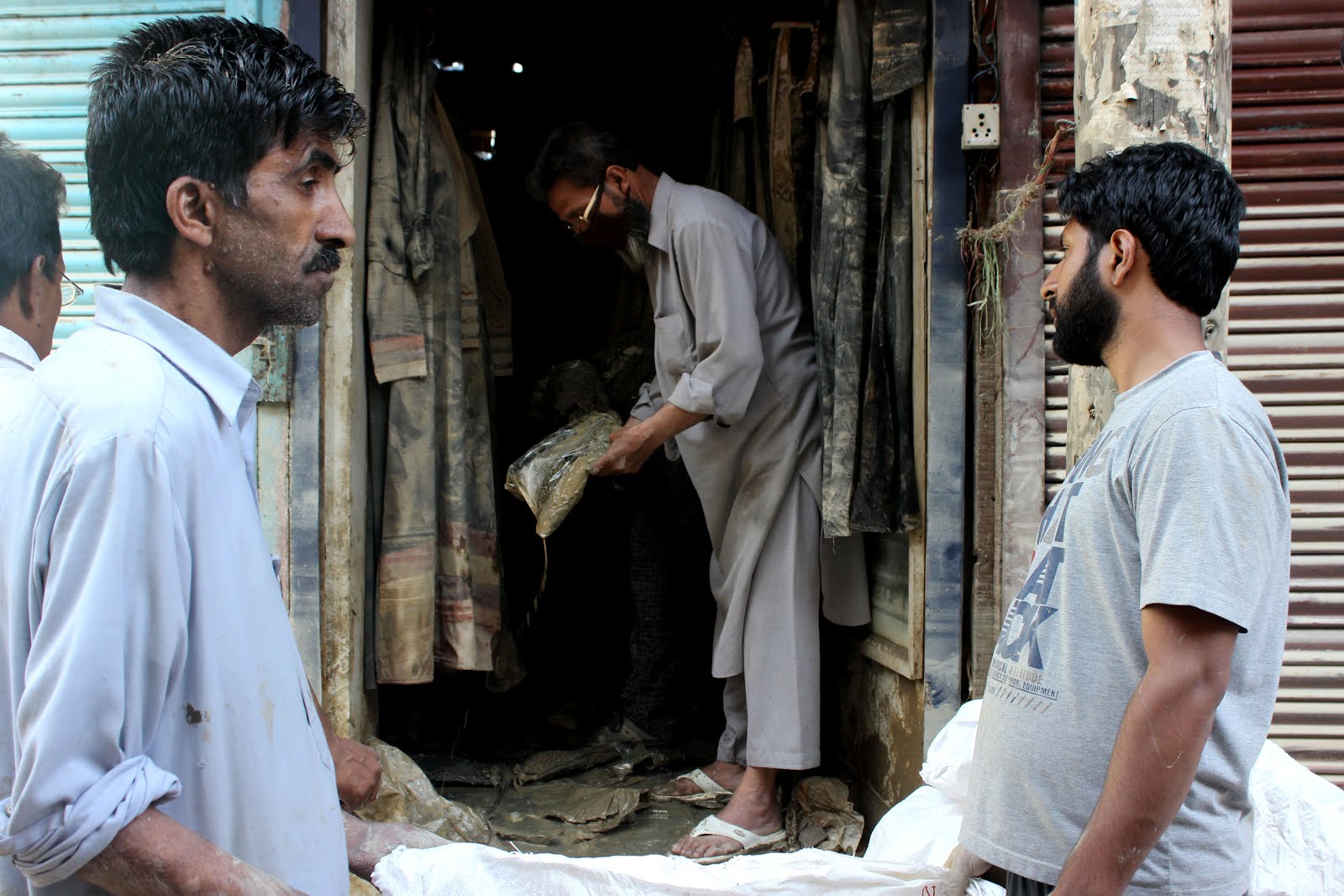 A shopkeeper removing the flooded material from his shop I one of the busy markets of Srinagar after floods.jpg