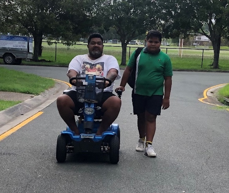Donny on mobility scooter despite spinal cord injury