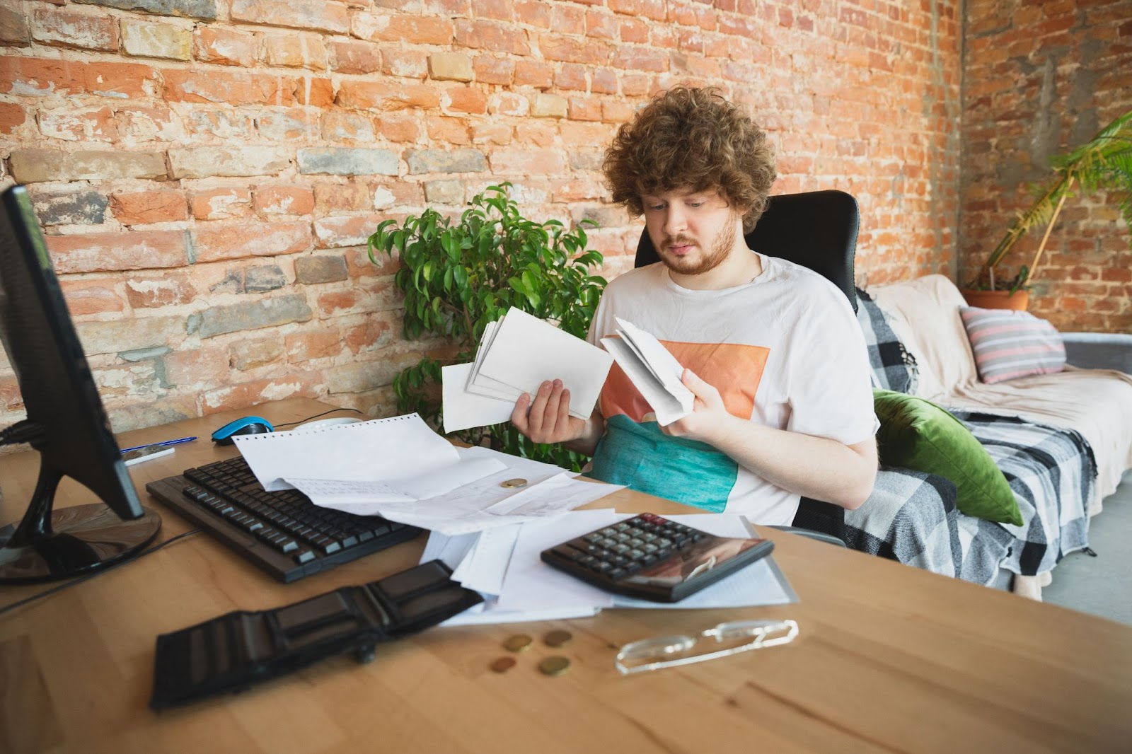 person looking in his bills 