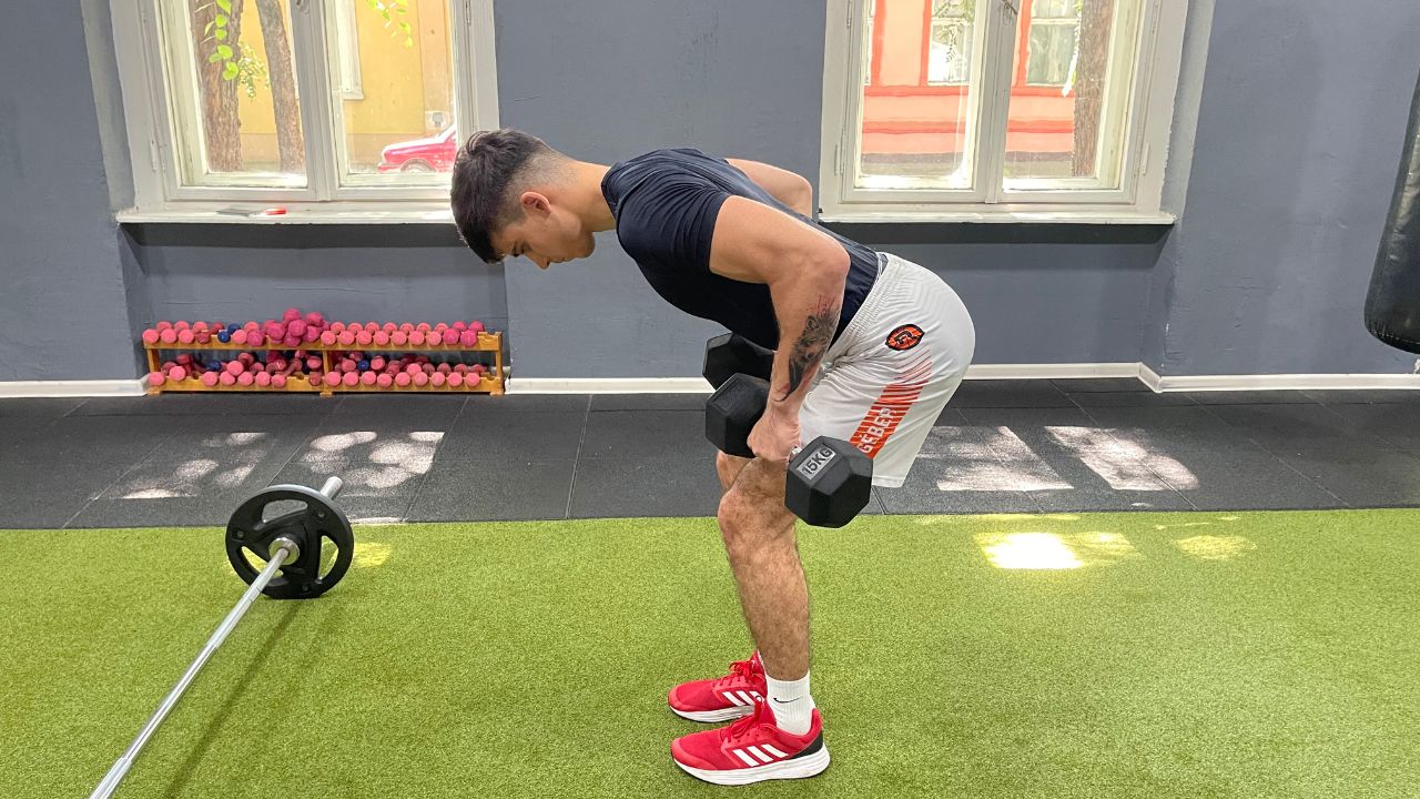 Vanja performs bent-over dumbbell rows.