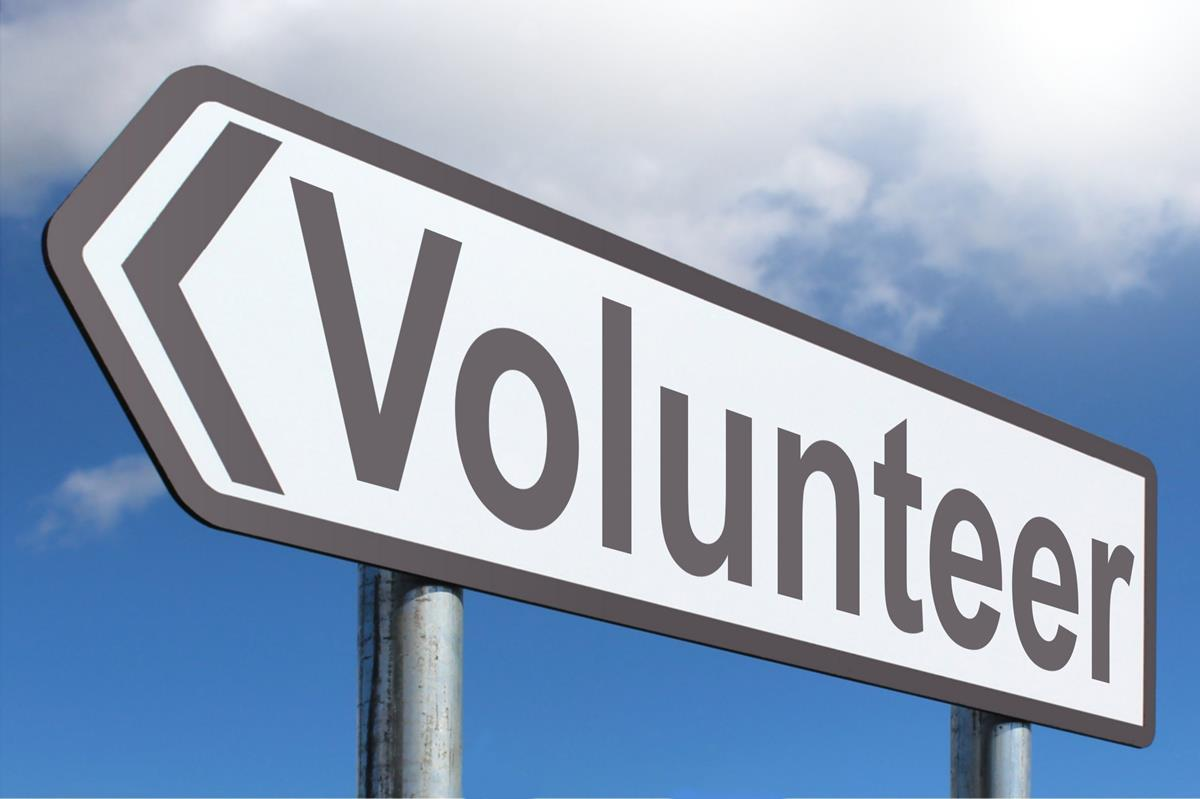 highway sign saying volunteer one step to do new things