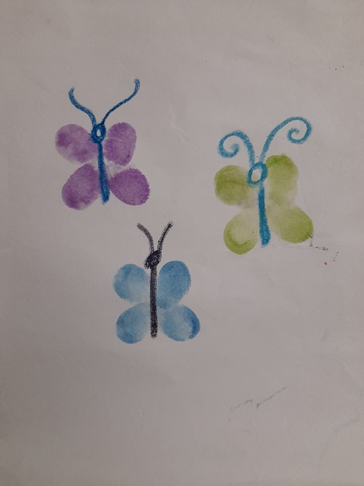 the same finger prints from the prior picture with the butterfly's bodies added in with crayon.