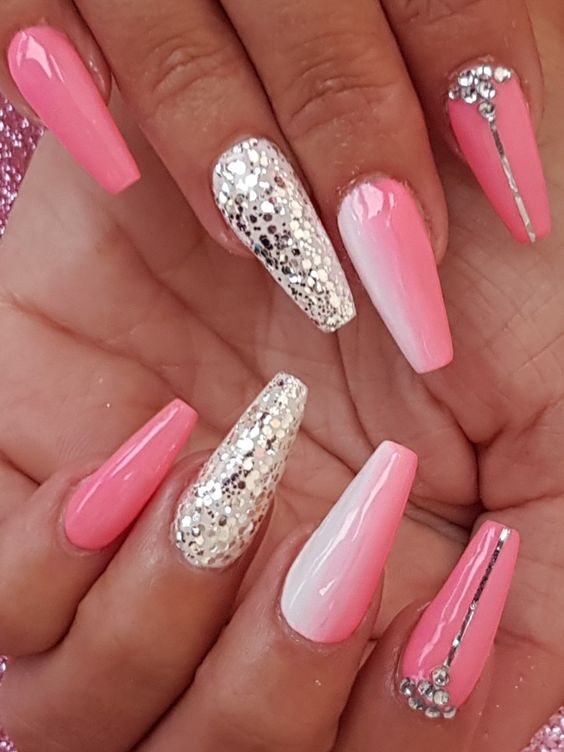 Close up view of a lady rocking the pink and glitter nails