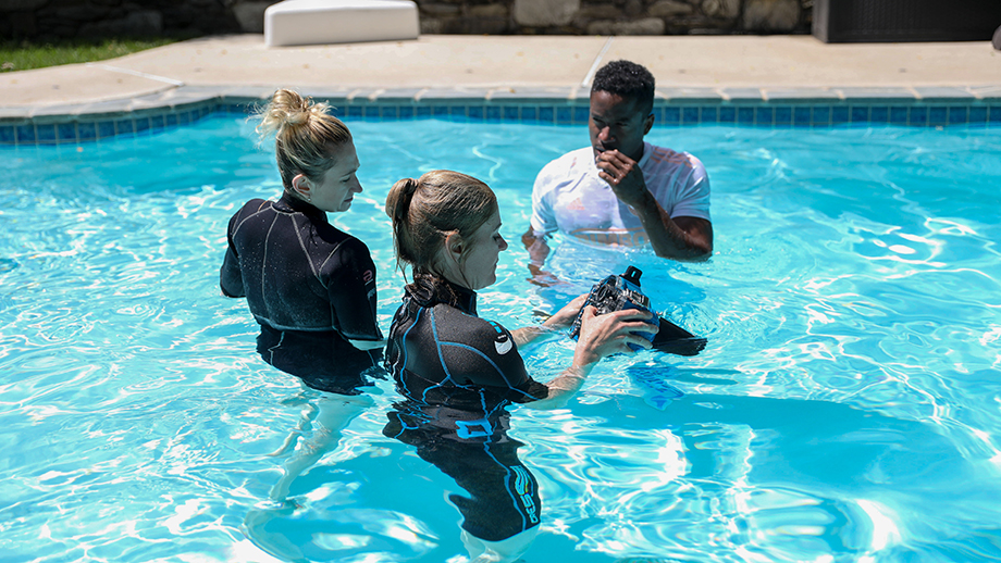 Photographer Julia Lehman works with her assistant Sarah Bower to coach Philadelphia Union soccer player Sergio Santos on how to pose for underwater photographs.