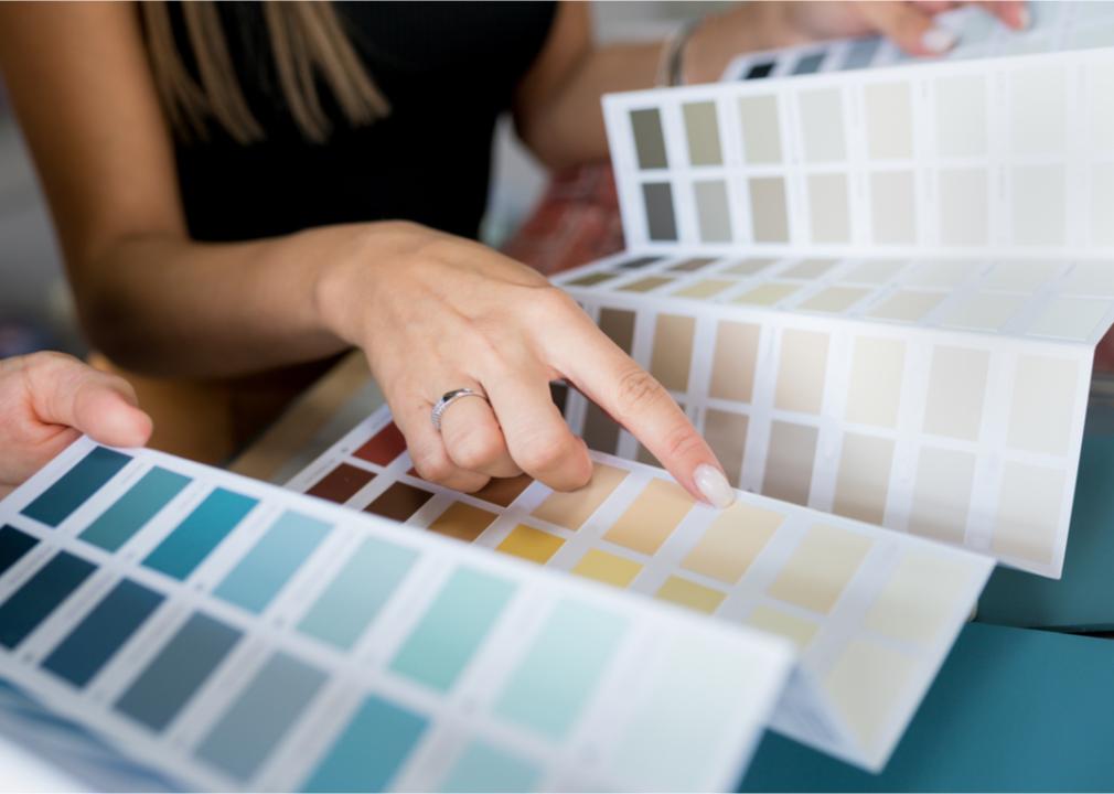 Real estate investor choosing neutral paint colors for a successful house staging. 