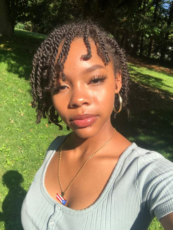 a girl wearing hoop earrings and twists