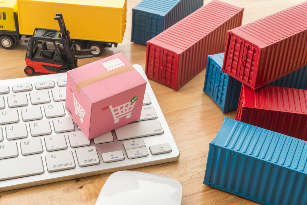 keyboard and miniature shipping boxes and containers to illustrate e-commerce