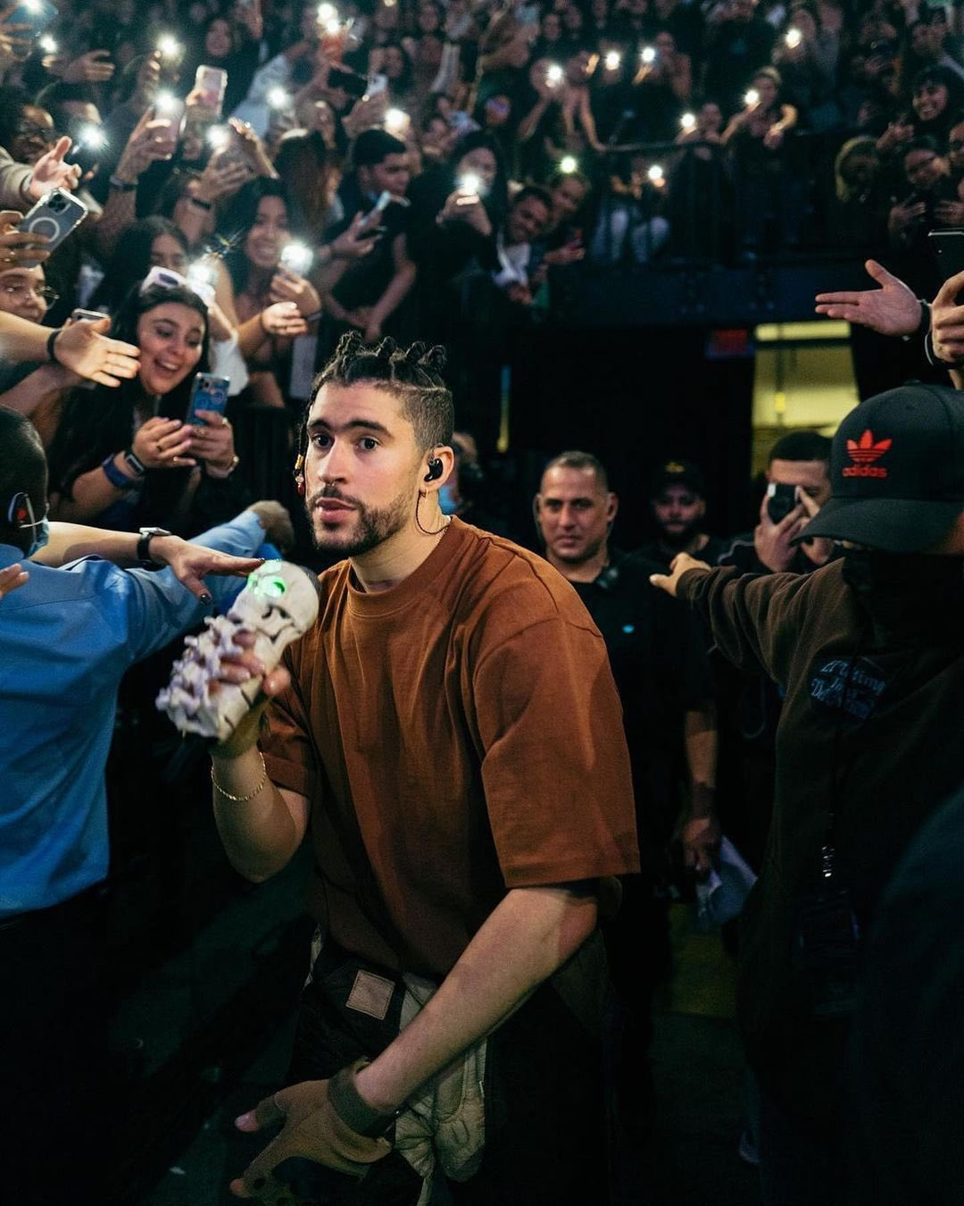 Bad Bunny on his way to the stage surrounded by fans