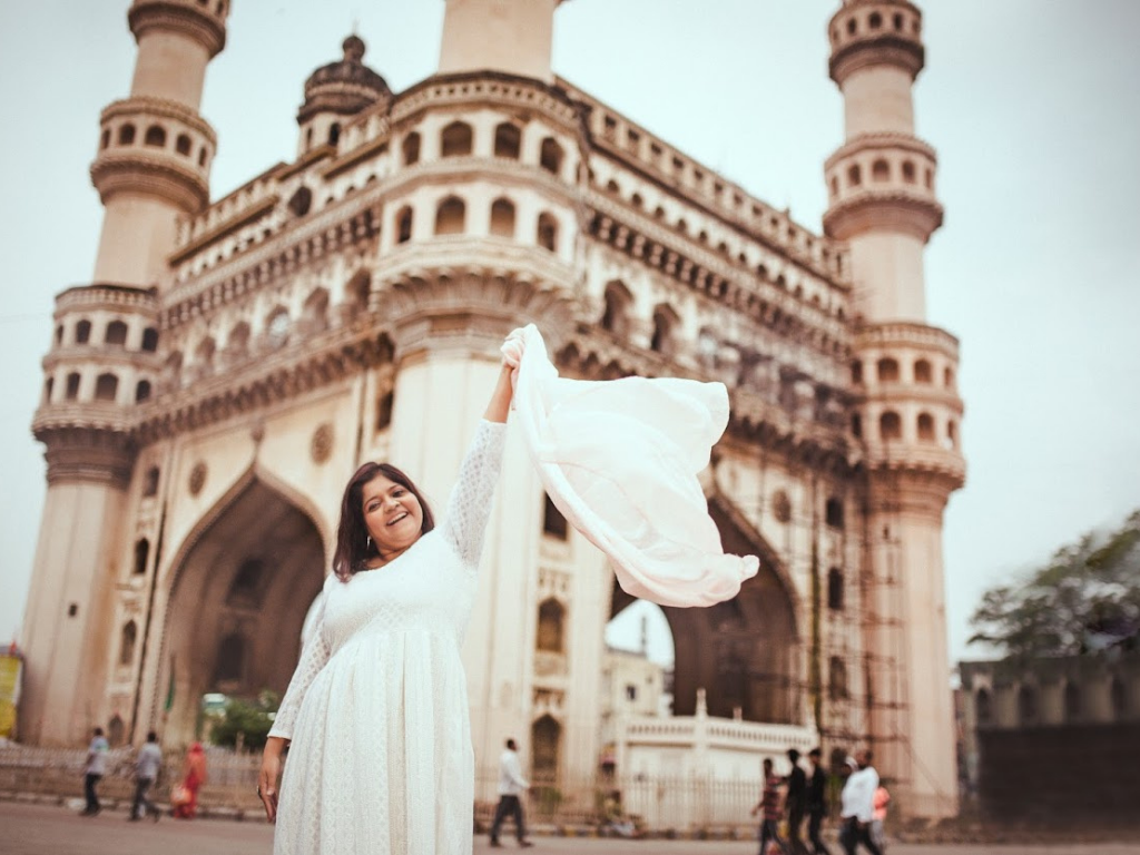 Woman in white dress outside Charminar in Hyderabad 